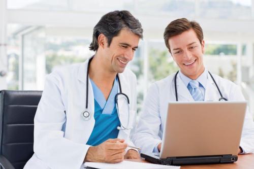 WebCME Doctors looking at laptop
