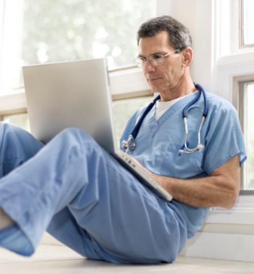 doctor with laptop on floor